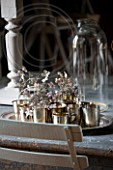 ROQUELIN, LOIRE VALLEY, FRANCE: DINING TABLE WITH SILVER TRAY AND TEA LIGHT HOLDERS WITH SILVER GREY HYDRANGEA FLOWERS