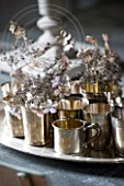 ROQUELIN, LOIRE VALLEY, FRANCE: DINING TABLE WITH SILVER TRAY AND TEA LIGHT HOLDERS WITH SILVER GREY HYDRANGEA FLOWERS